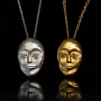 Face-mask pendant necklace with silver and gold chains and matching face pendants