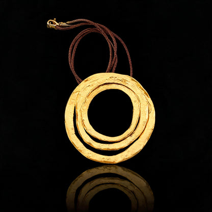 Gold pendant necklace with braided cord, double ring round pendant