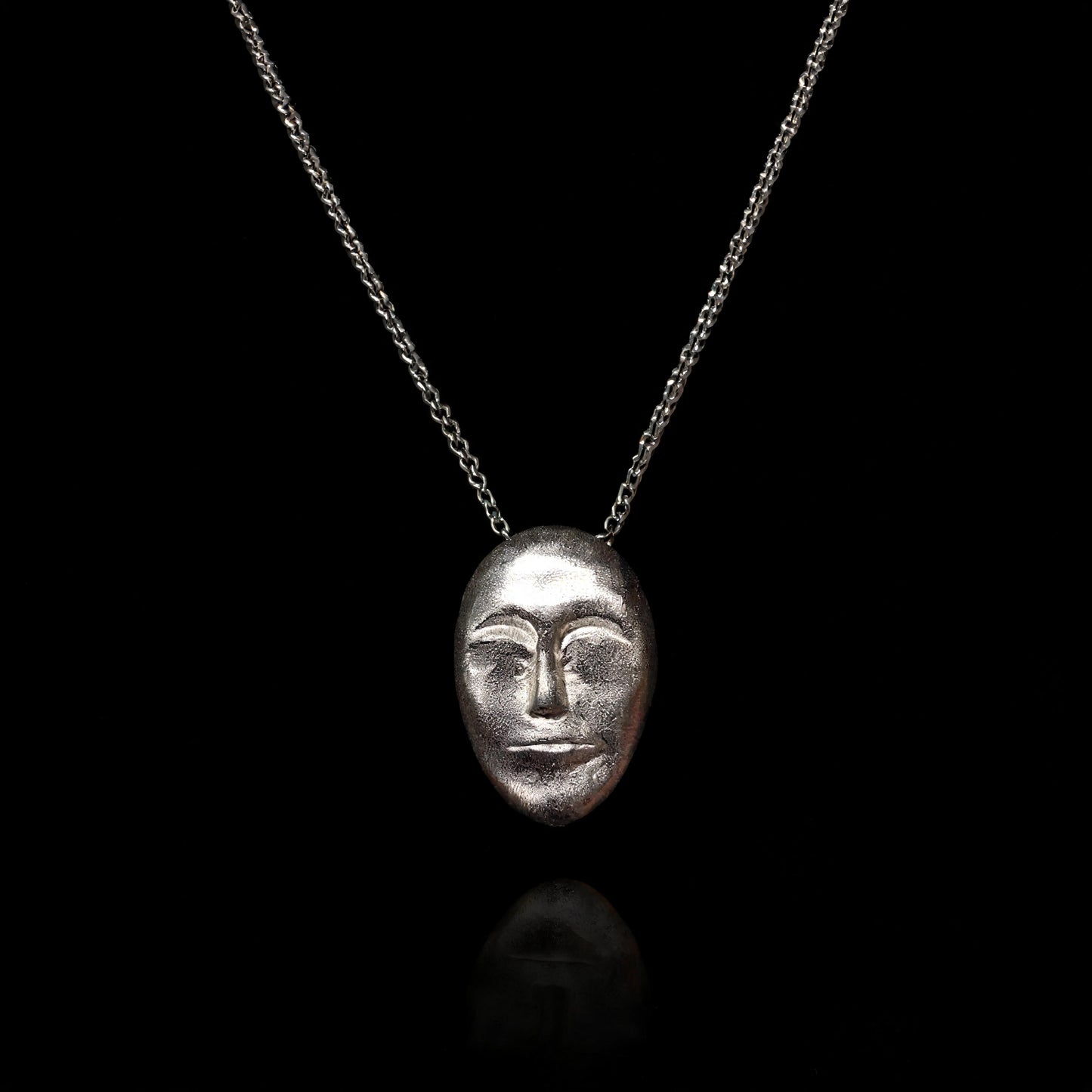 Silver face-mask pendant necklace with a fine chain link