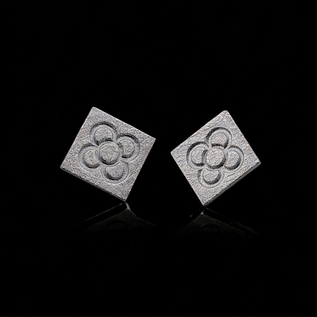 Silver square flower stud earrings with embossed quatrefoil pattern