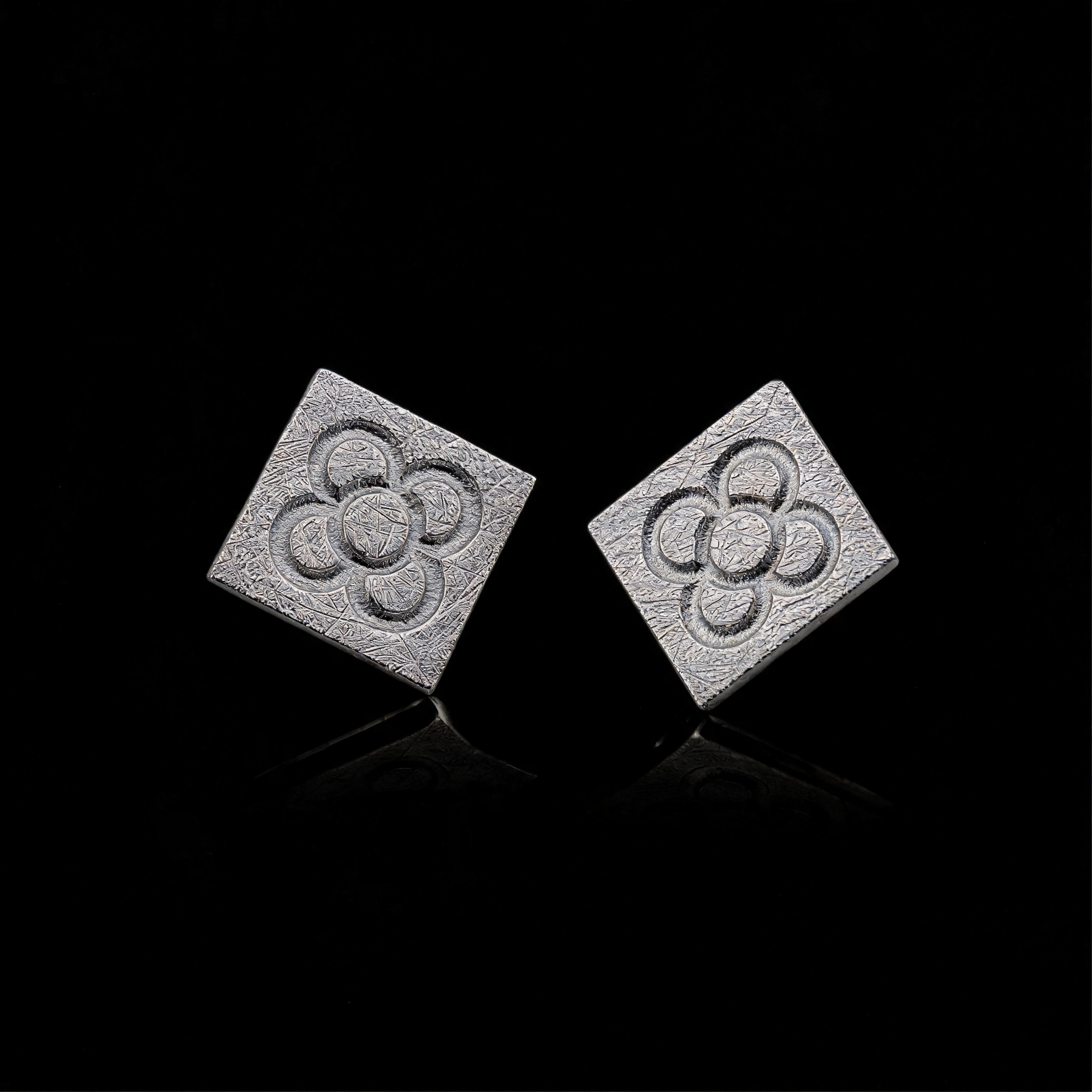 Silver square flower stud earrings with embossed quatrefoil pattern