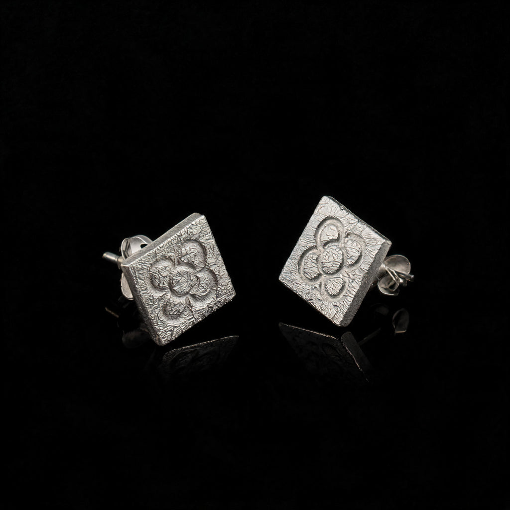 Silver square flower stud earrings with butterfly backs and embossed quatrefoil
