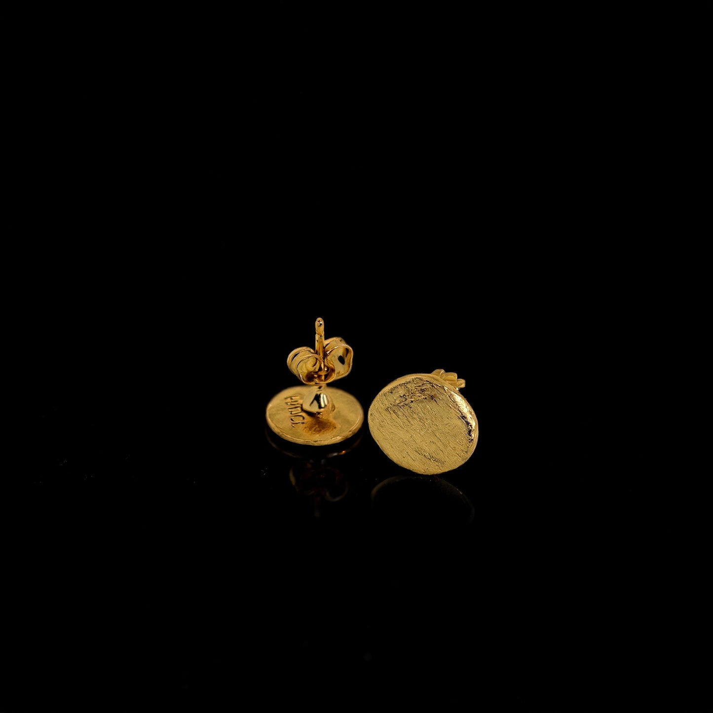 Gold round stud earrings with textured disc and small hanging detail