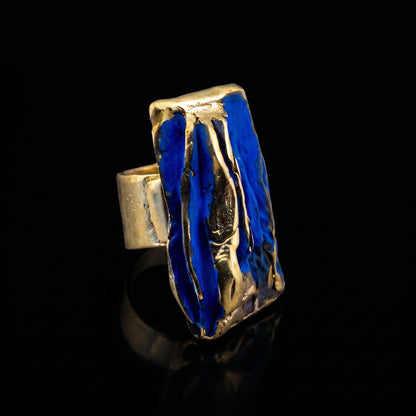 Rectangular sculpted ring with blue resin panels and gold-tone textured edges