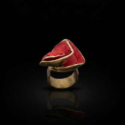Rosella ring with gold-tone band and red triangular gemstone top with pale edging