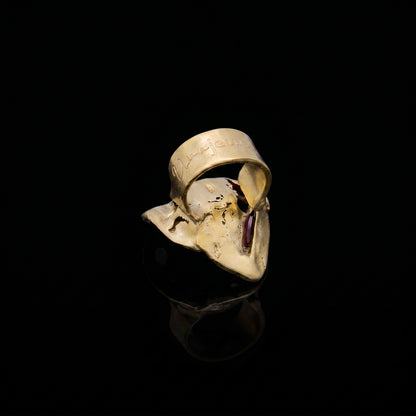 Gold-tone face-shaped ring with red inner detail and open front