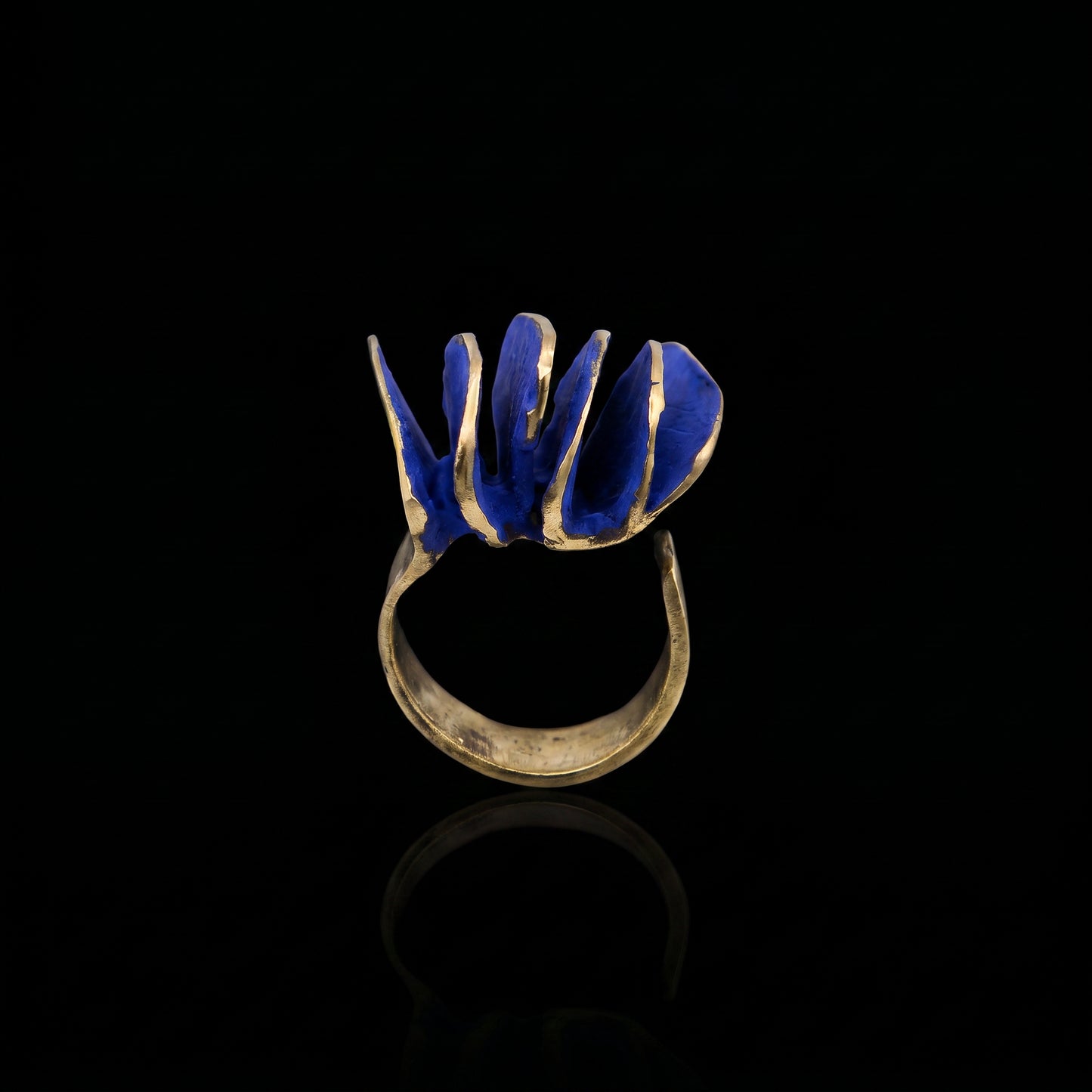 Gold-tone ring with blue wave inlay, open-top view