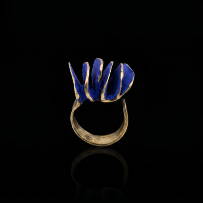 Gold-tone ring with blue wave inlay, open-top view