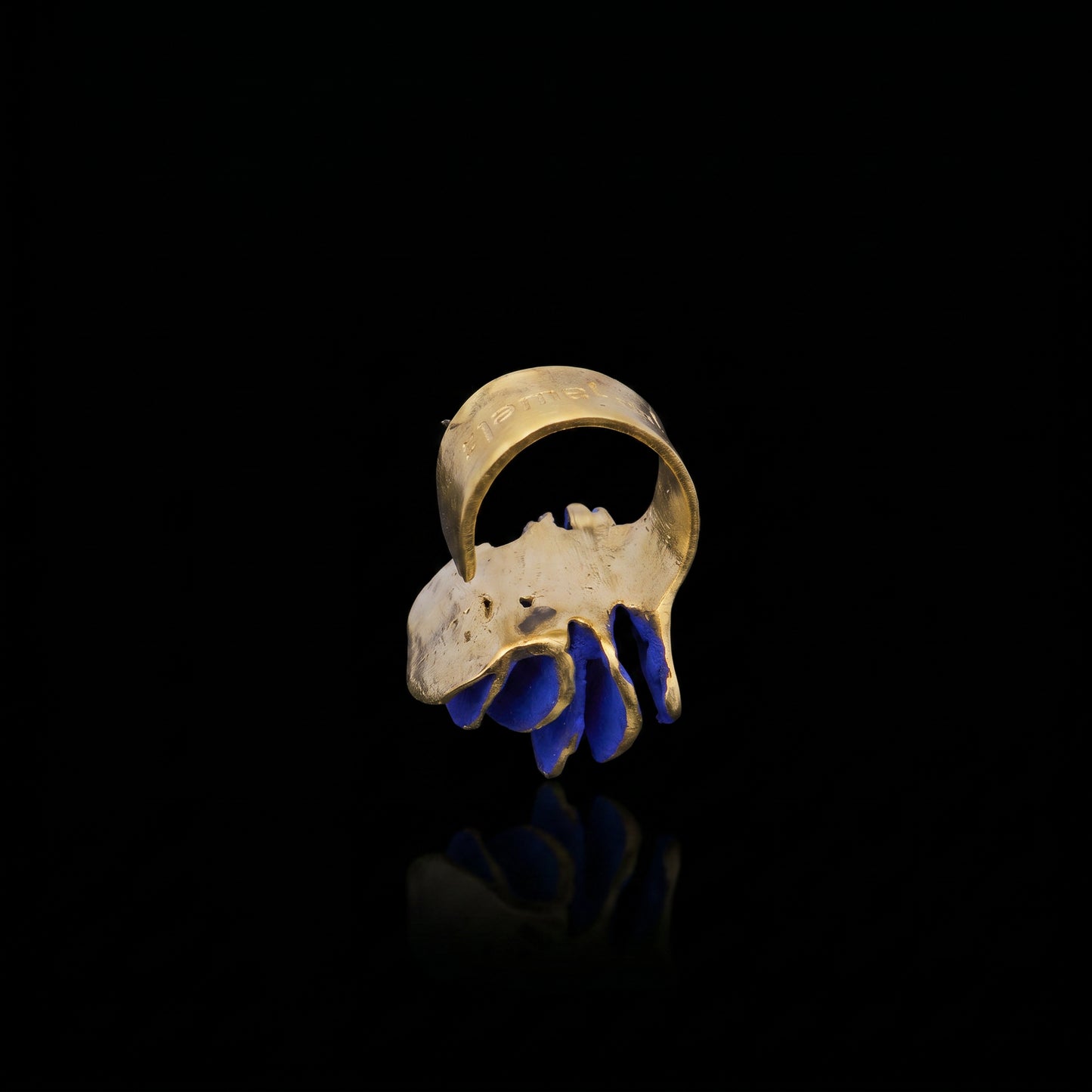 Gold-tone ring with blue curved inlay detail
