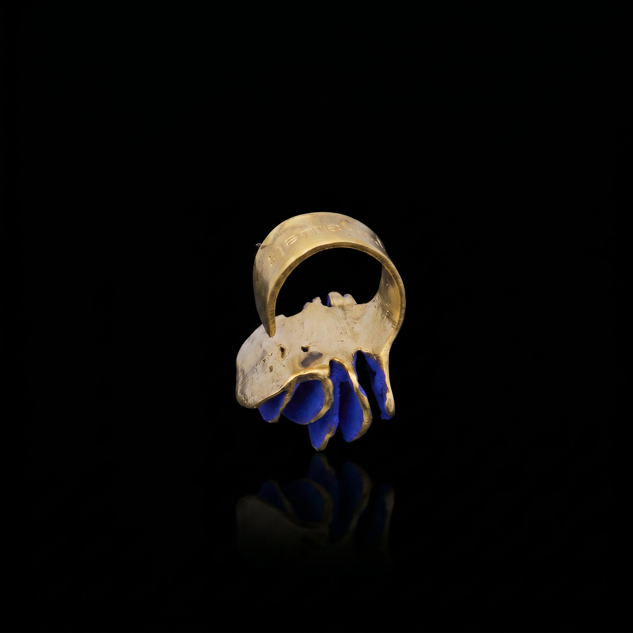Gold-tone ring with blue curved inlay detail