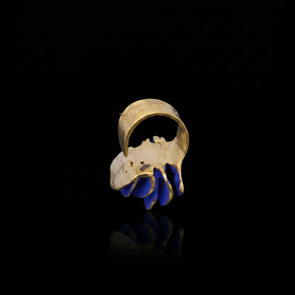 Gold-tone ring with blue curved inlay detail