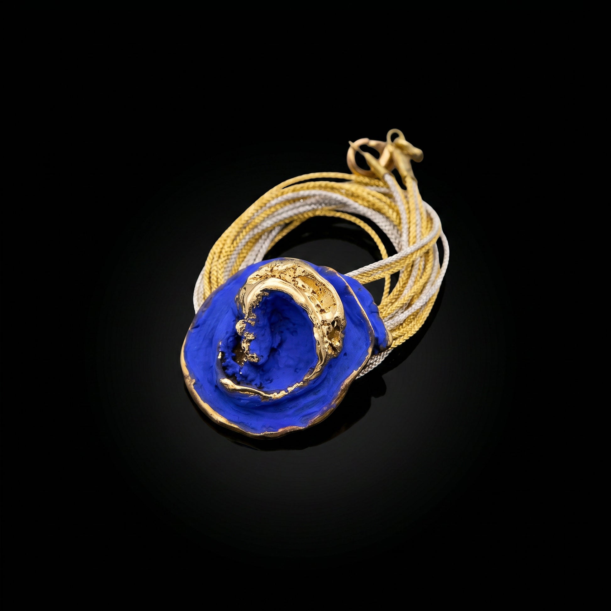 Blue stone pendant necklace with gold-toned frame and braided gold cord loop