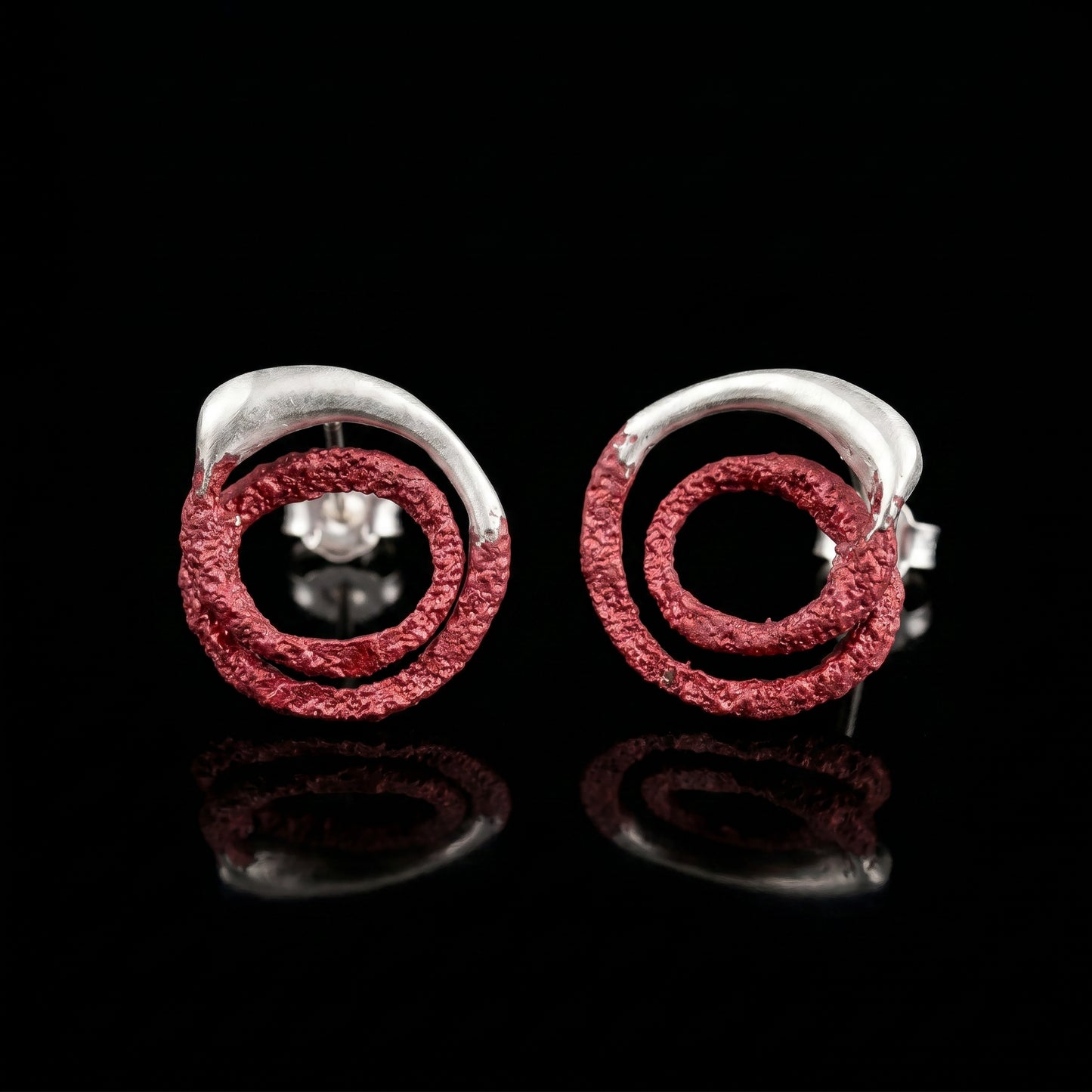 Trace hoop earrings with red textured rings and silver posts