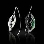 Pair of veined leaf earrings with black and green accents, silver-tone curved backs.