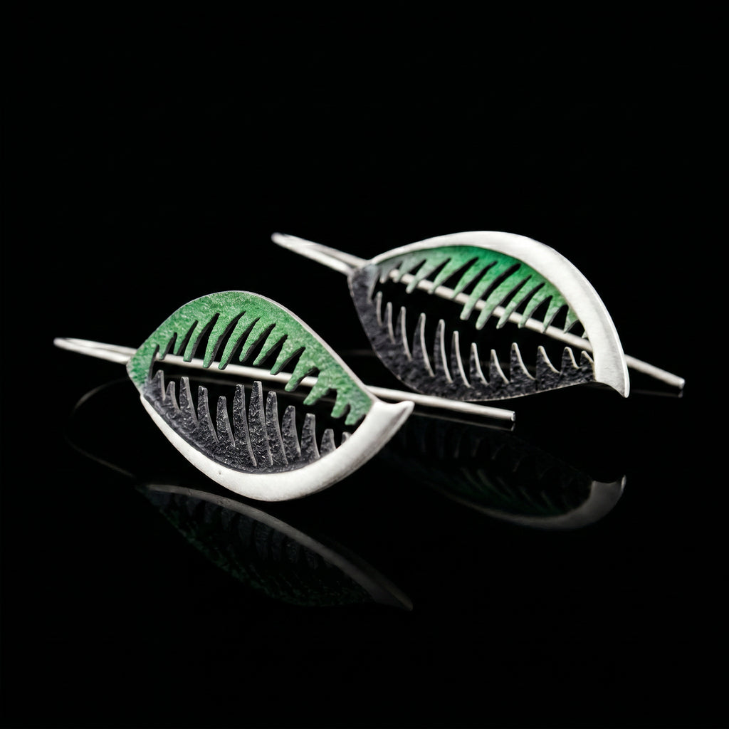 Veined leaf-shaped earrings with green and black detail, silver-tone wire hooks.