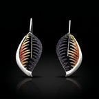 Veined leaf earrings with bronze-orange and black veining, silver-tone teardrop backs.