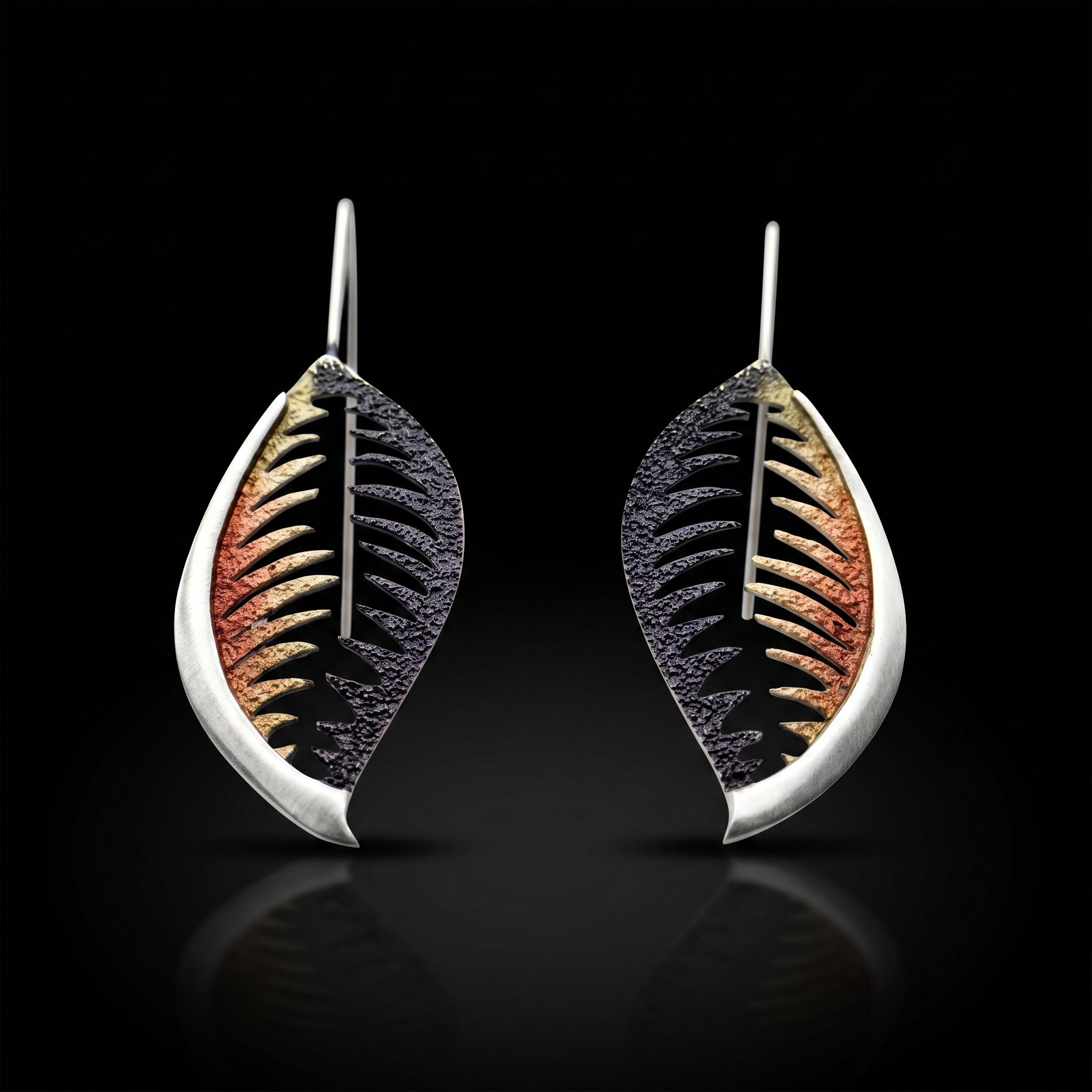 Veined leaf earrings with bronze-orange and black veining, silver-tone teardrop backs.
