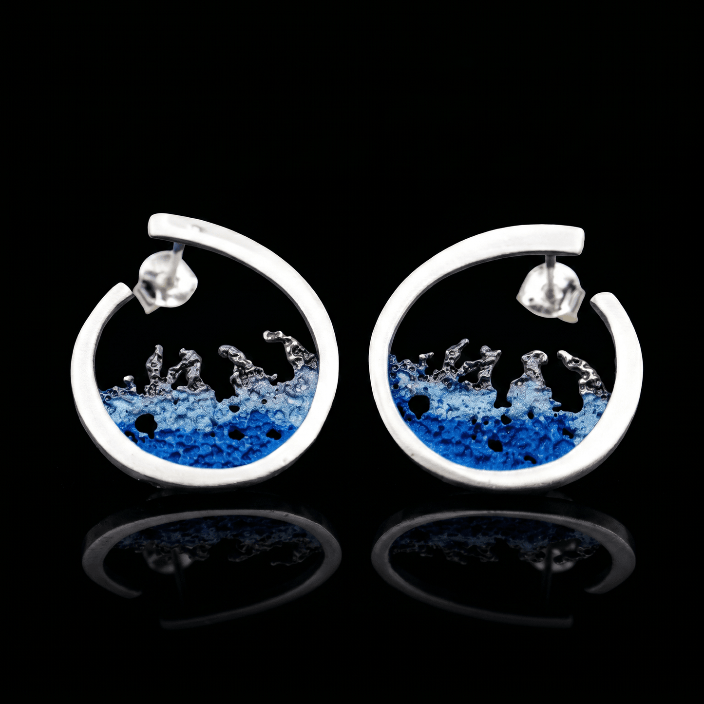 Silver hoop earrings with blue resin splash design