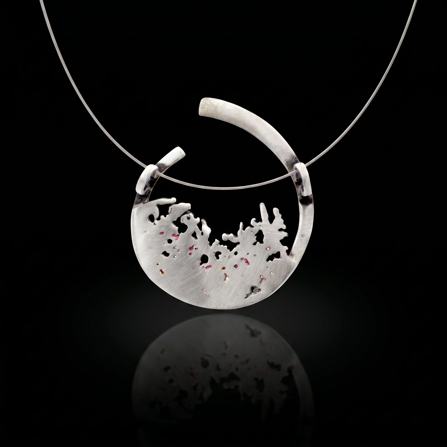 Silver 925 pendant with teardrop bezel and pale textured inlay with dark speckles