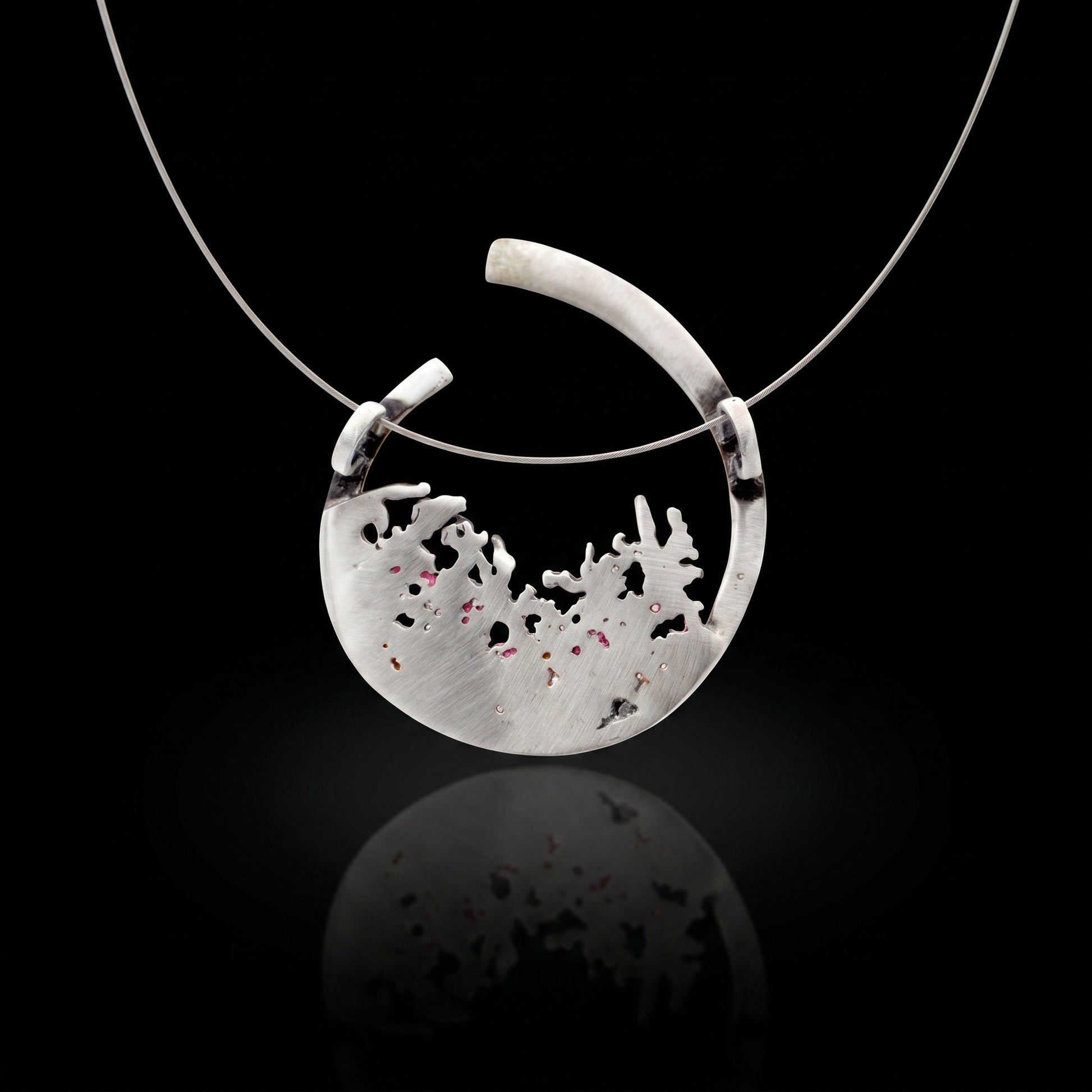 Silver 925 pendant with teardrop bezel and pale textured inlay with dark speckles