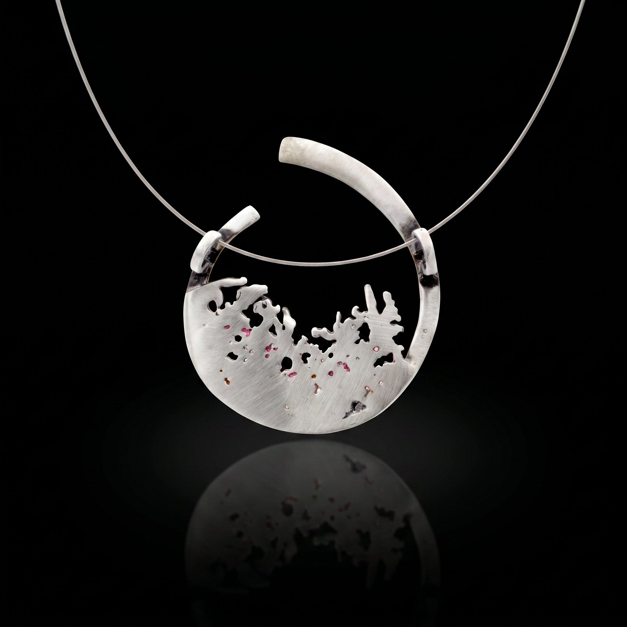 Silver 925 pendant with teardrop bezel and pale textured inlay with dark speckles