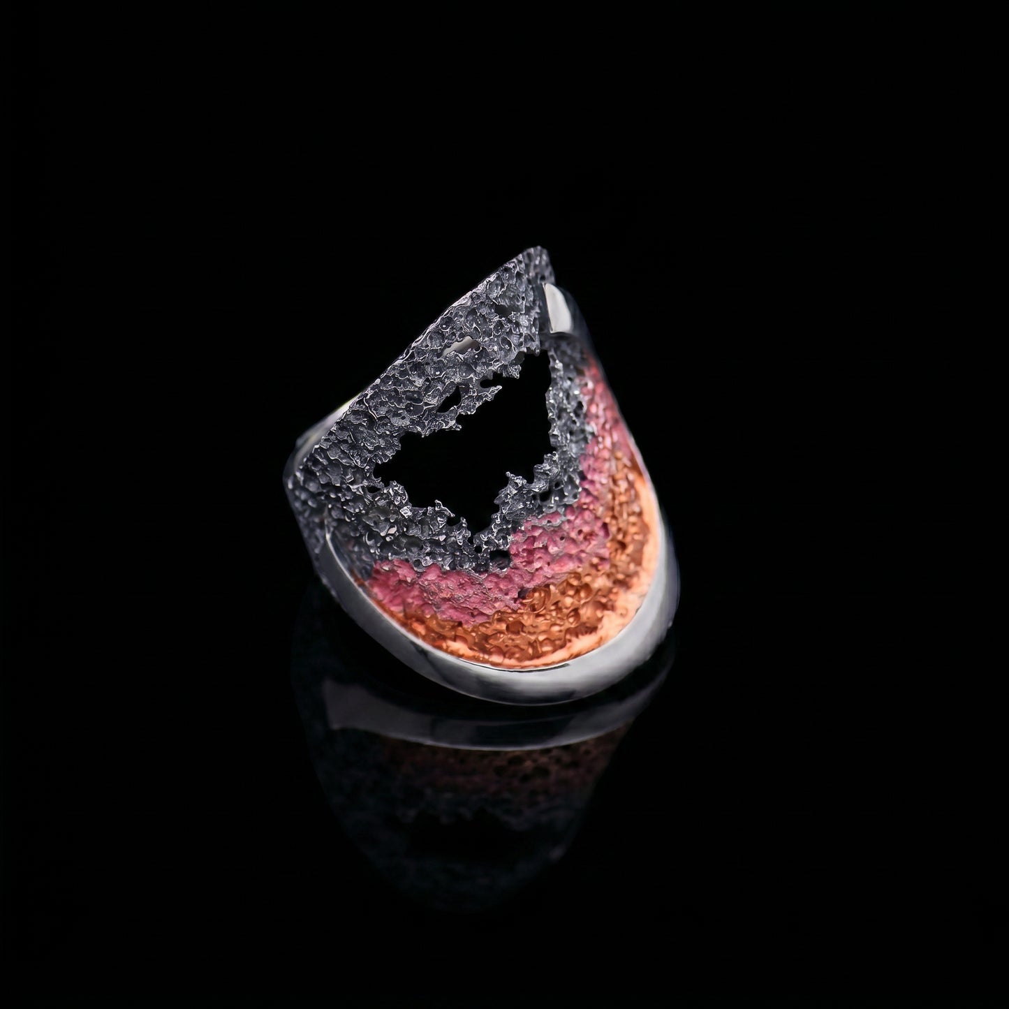 925 ring with textured silver band and red-orange ocean swirl inset, angled