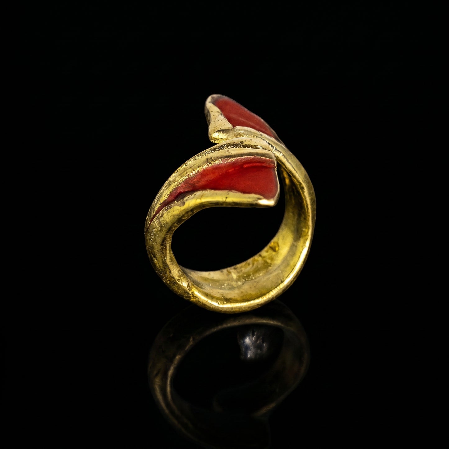 Gold dragon claw ring with red enamel inset, close-up open band