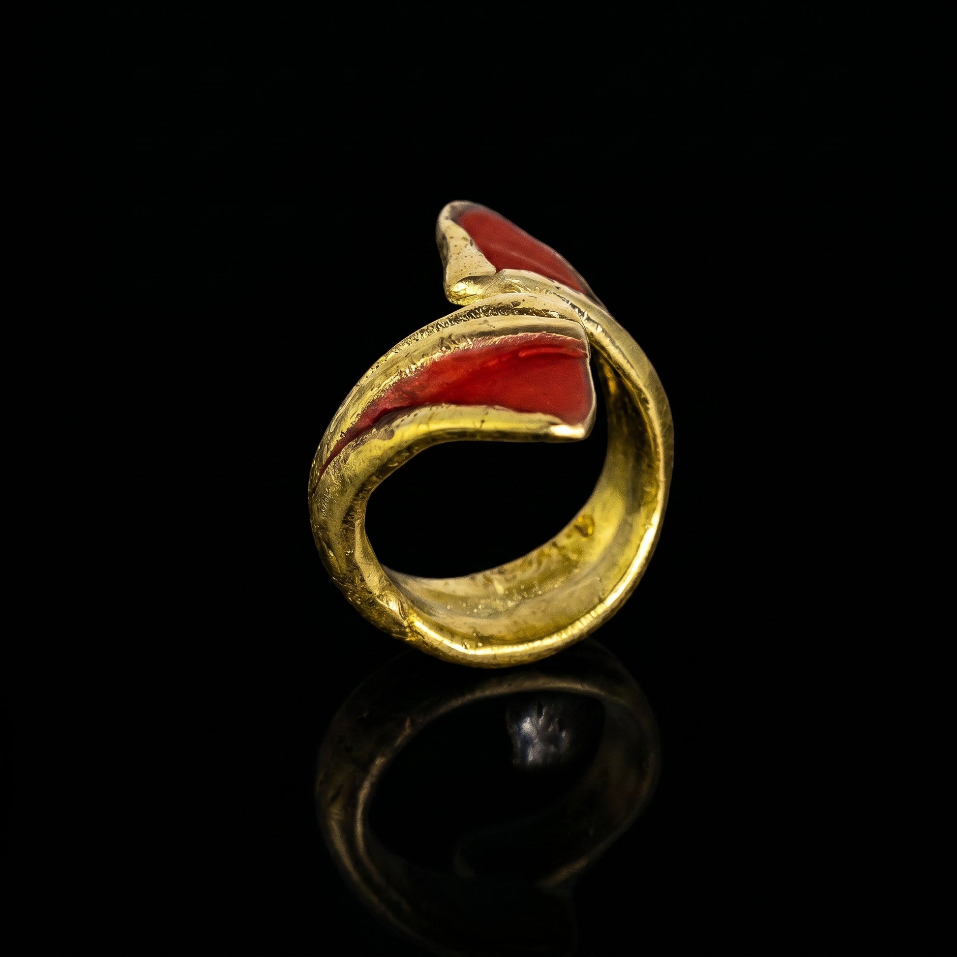 Gold dragon claw ring with red enamel inset, close-up open band
