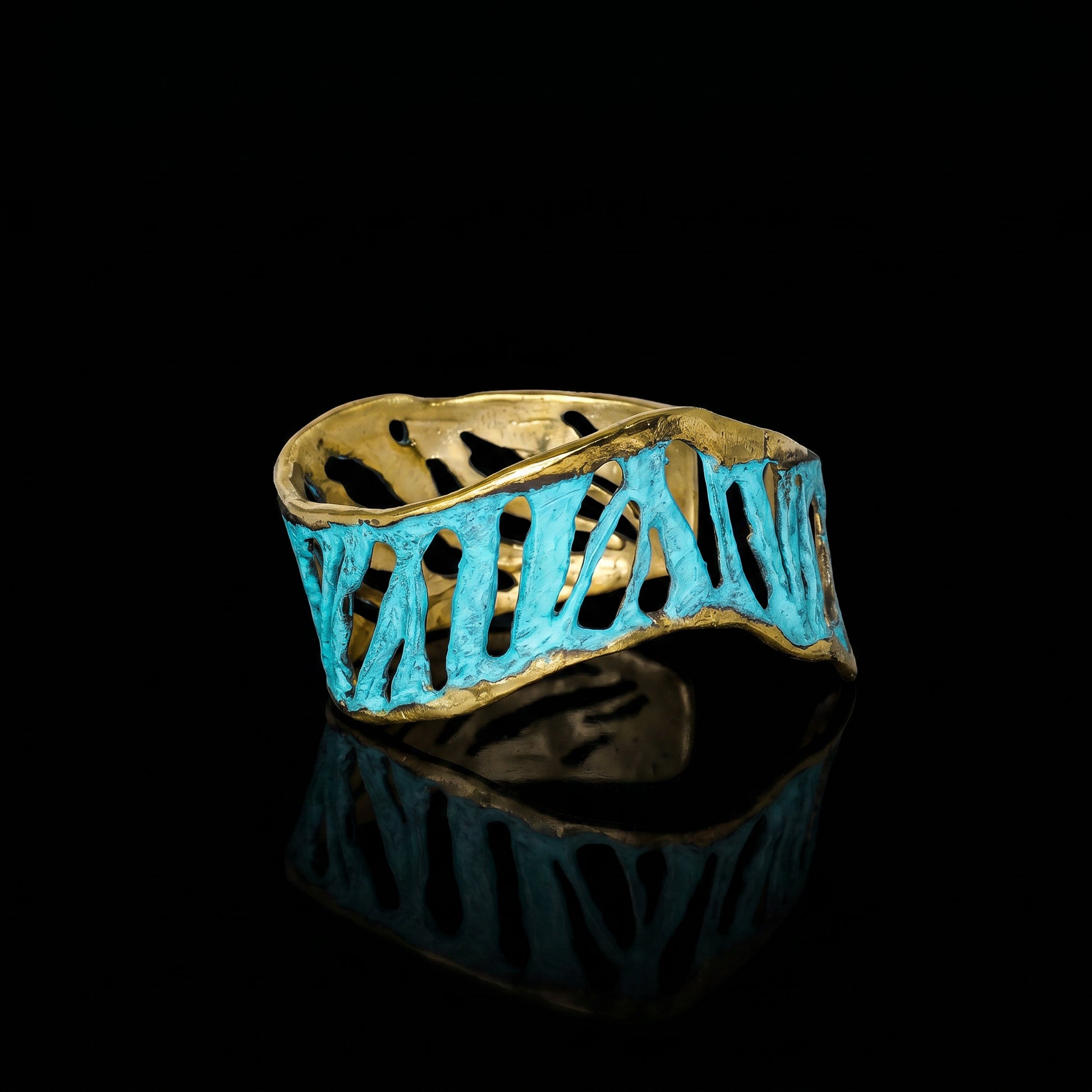 Turquoise cuff bracelet with gold-tone edges and cutout wave pattern