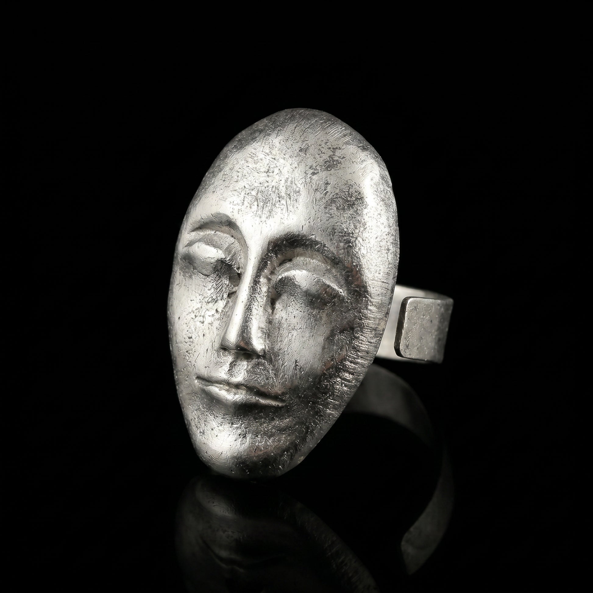 Silver oval face ring with textured sculpted profile and wide band
