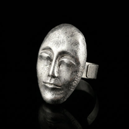 Silver oval face ring with textured sculpted profile and wide band