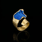 Gold-tone loop ring with irregular blue gemstone