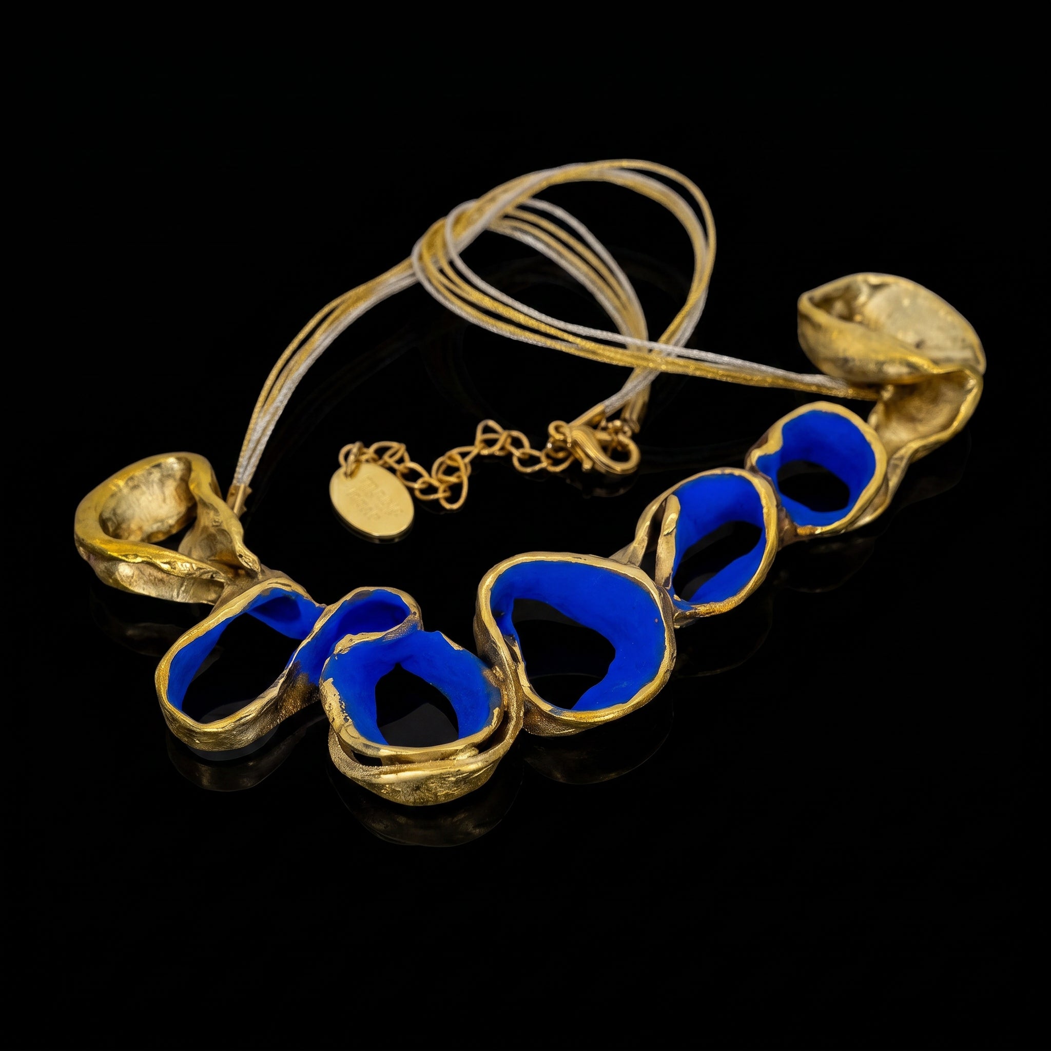 Gold-tone necklace with blue oval link beads and shell-shaped pendants