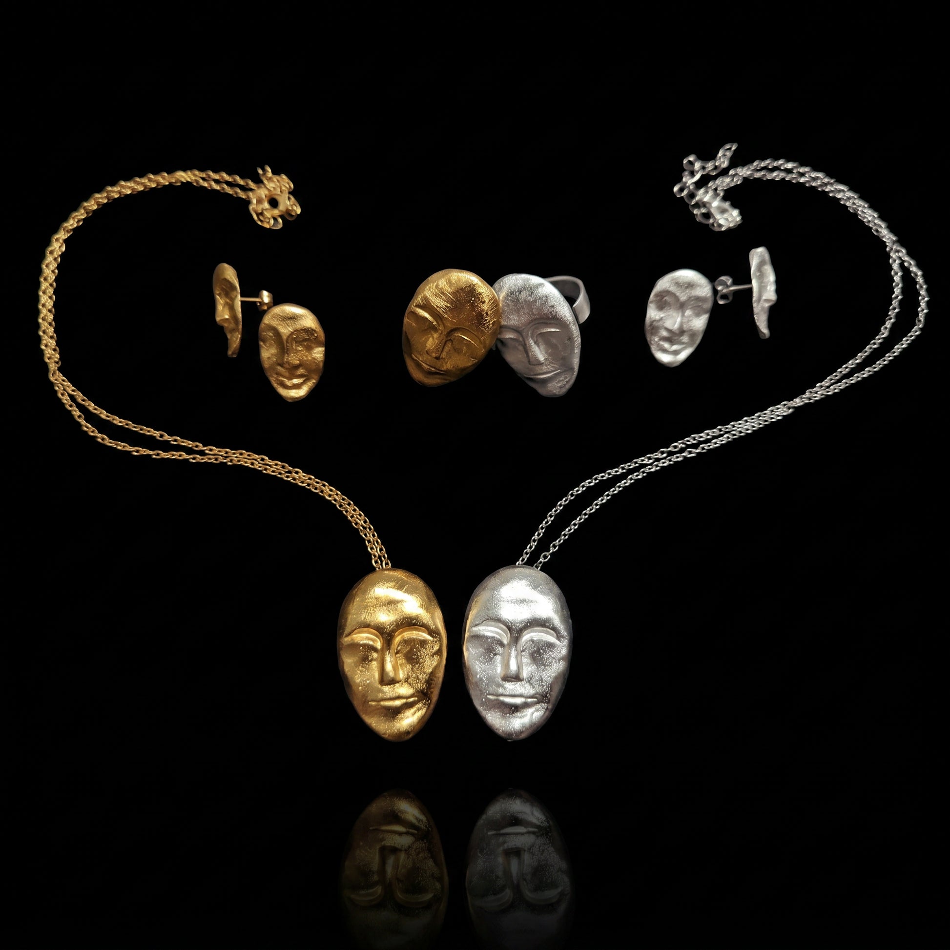 Face earrings set with thin chain necklace and small charm accents