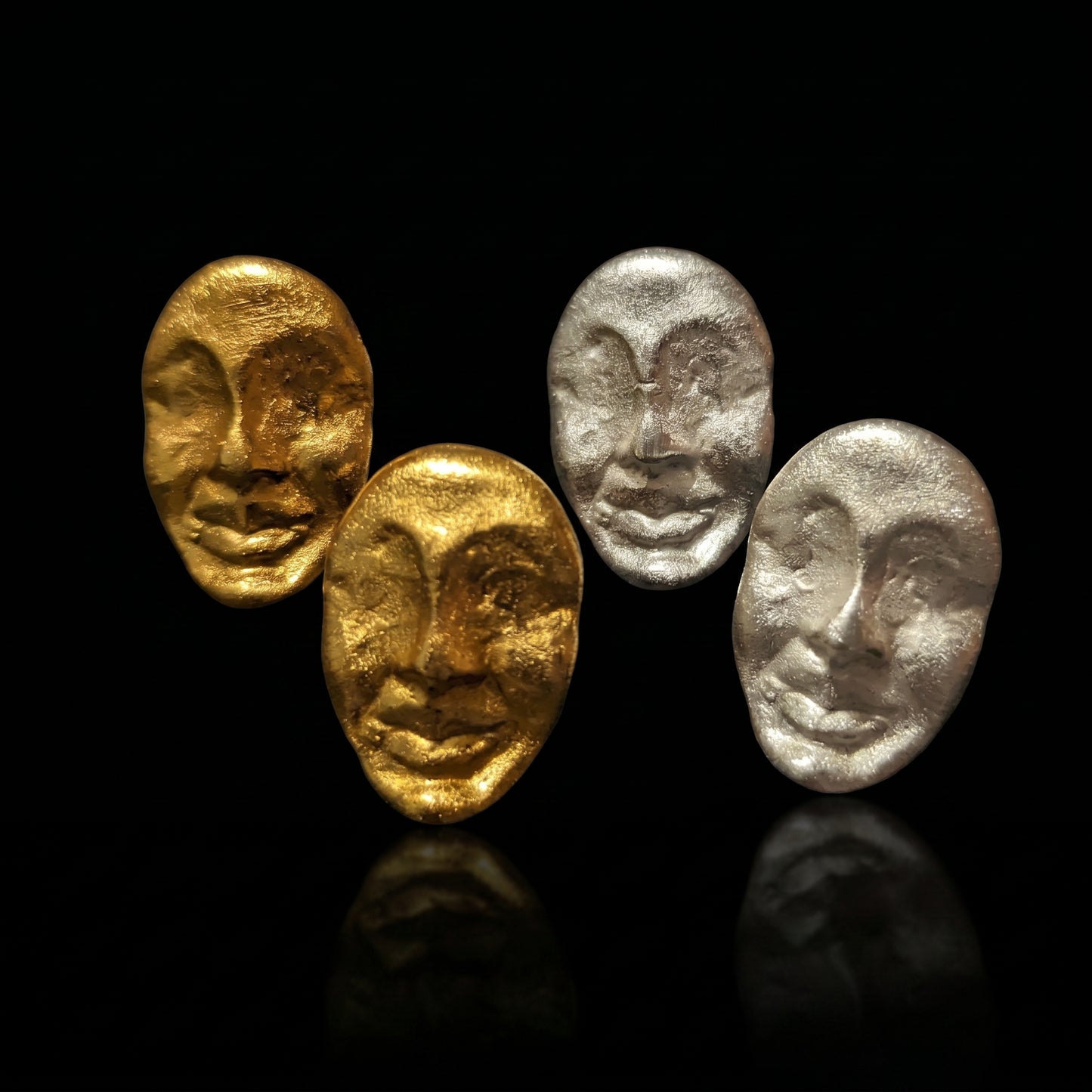 Four textured oval face earrings in gold and silver tones