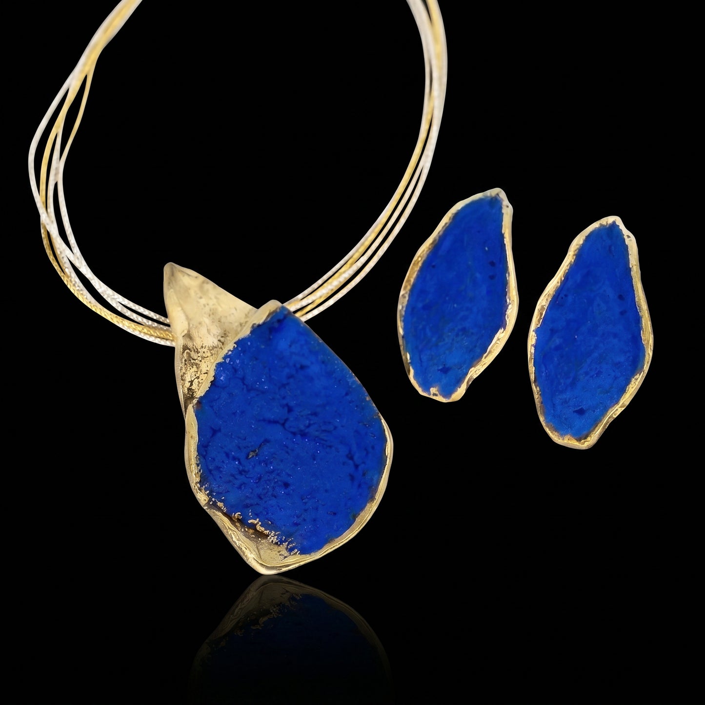 Gold-tone necklace with blue teardrop pendant and matching blue earrings