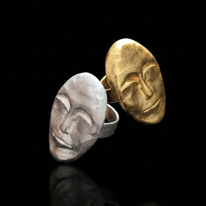 Pair of oval face rings, gold and silver, with textured sculpted profiles