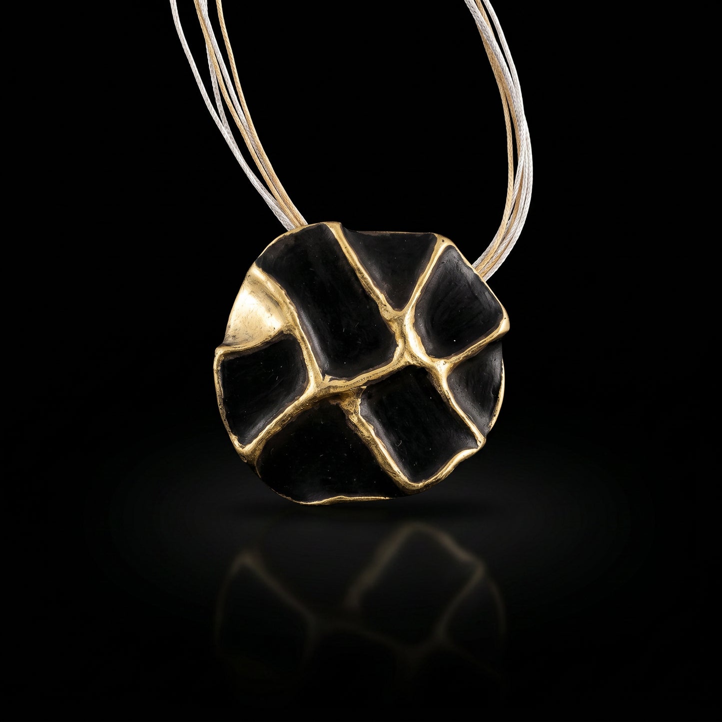 Gold-tone and black enamel concept necklace with oval pendant on thin chain
