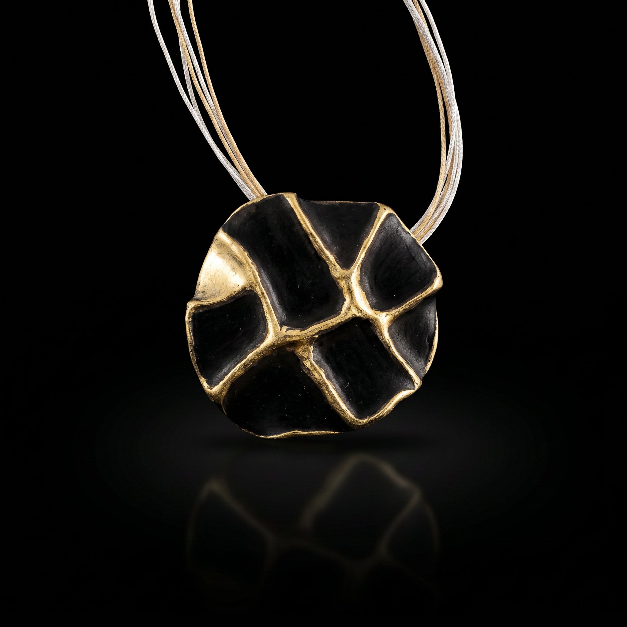 Gold-tone and black enamel concept necklace with oval pendant on thin chain