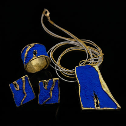 Blue enamel ring with gold-toned accents and black-inlaid detail, rounded band