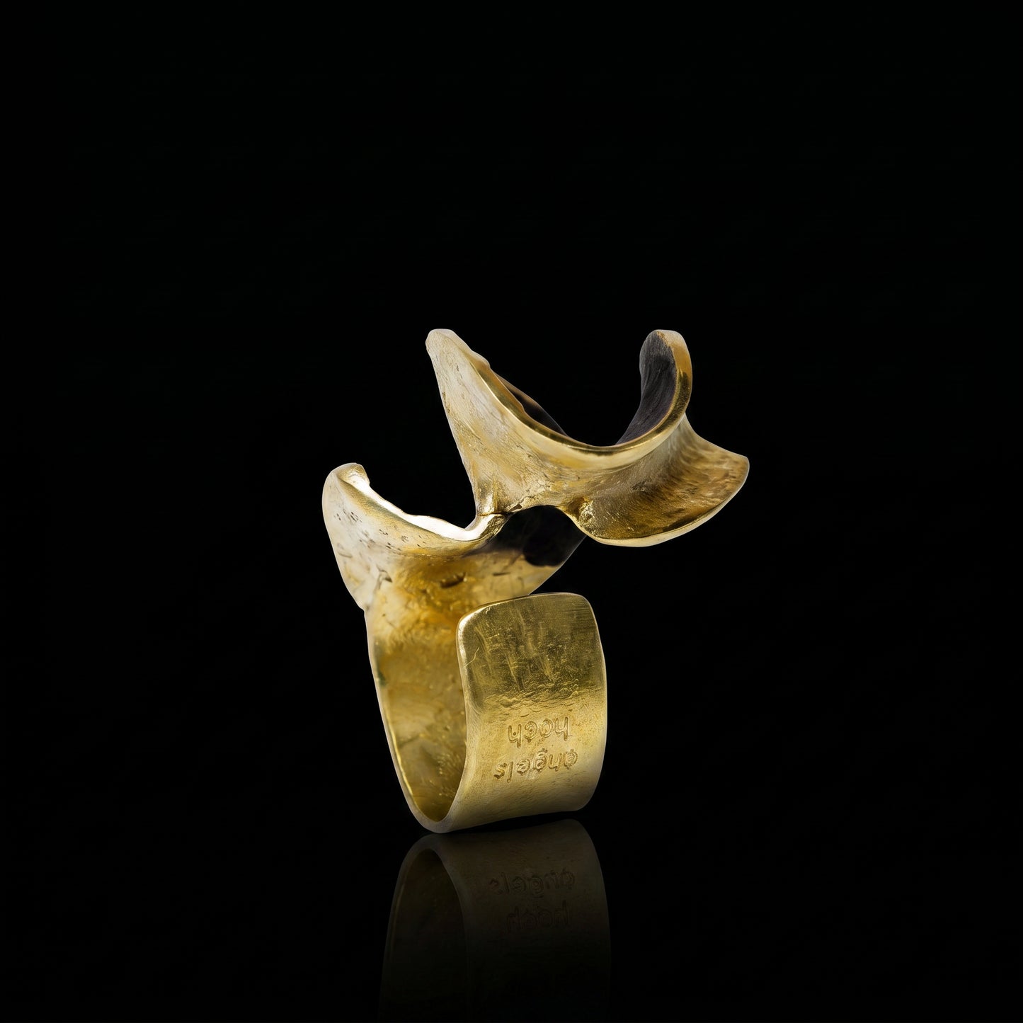 Gold sculptural ring with three curved bands