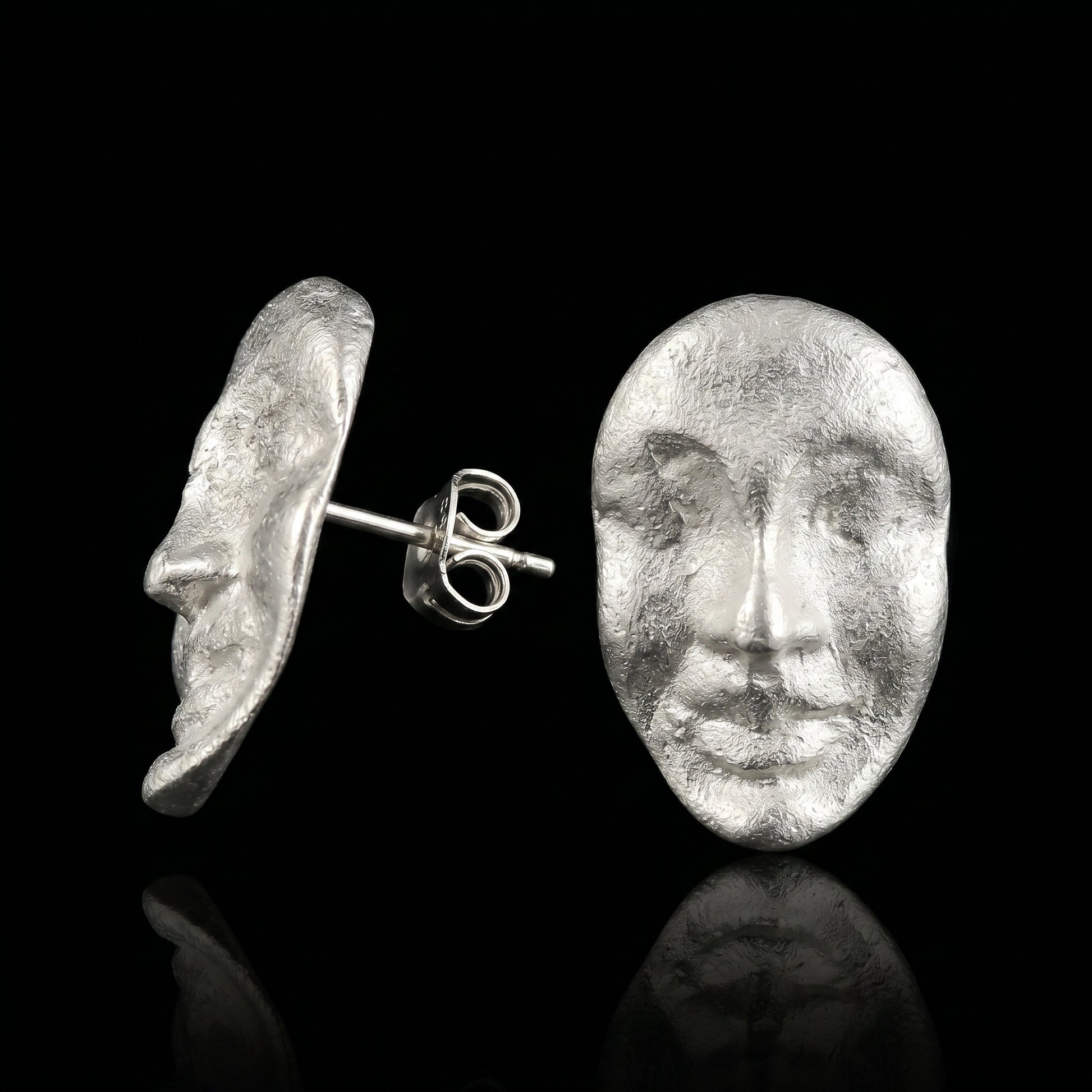 Silver face stud earrings with textured oval coin design and butterfly backs