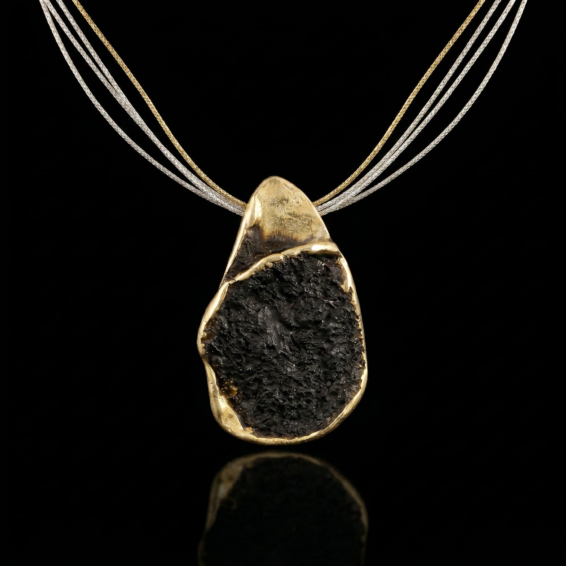 Gold-tone multi-strand necklace with dark stone teardrop pendant