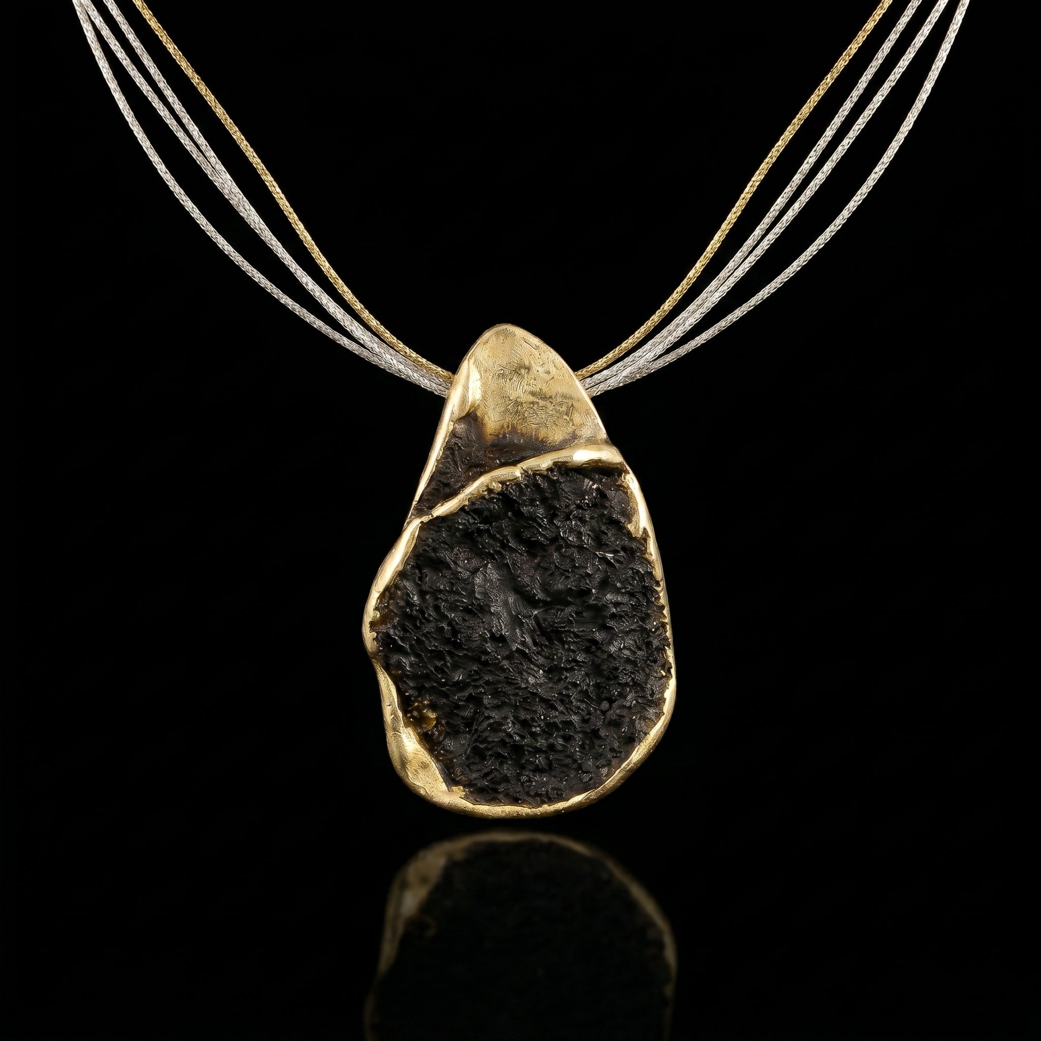 Gold-tone multi-strand necklace with dark stone teardrop pendant