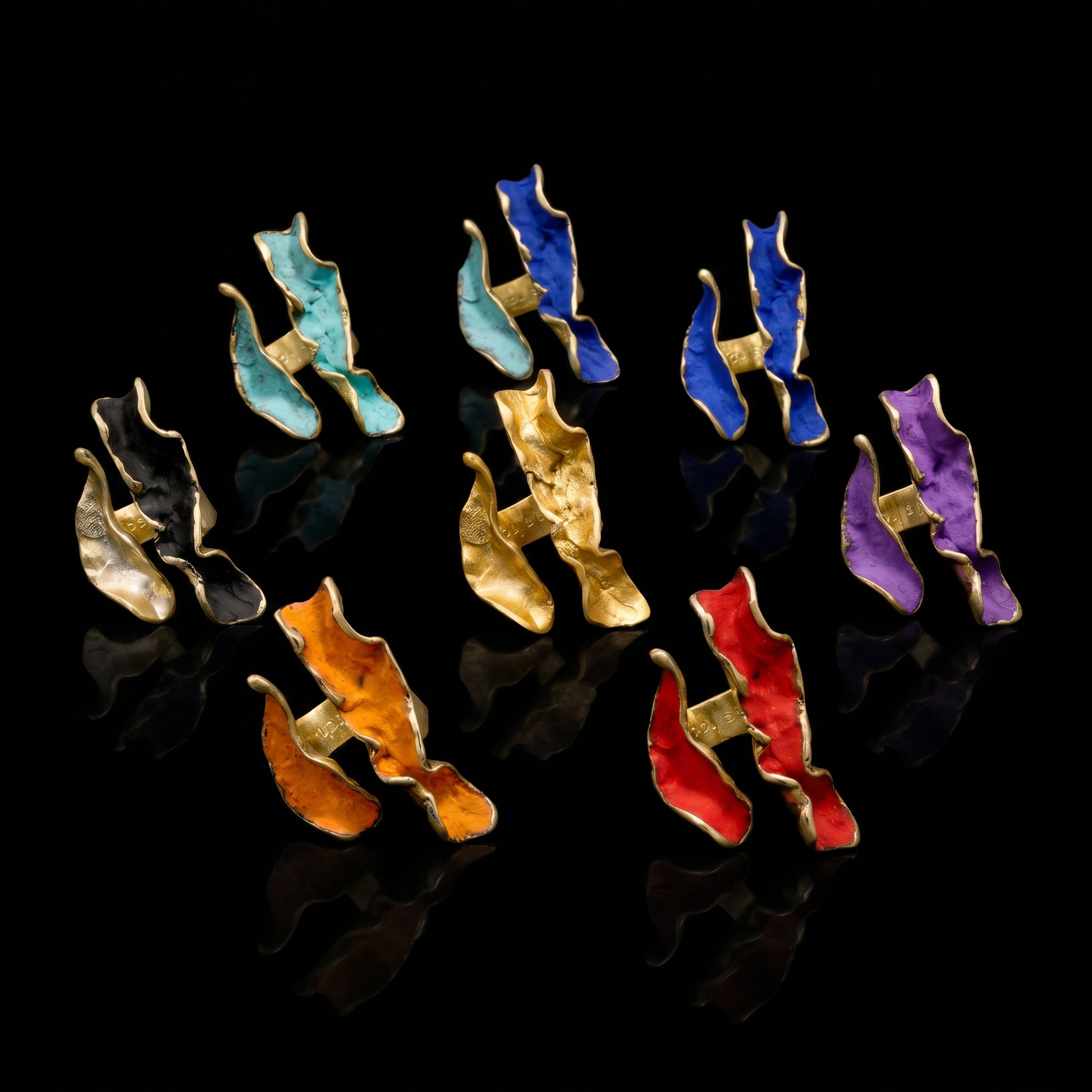 Assorted wave rings with gold-tone settings and colorful enamel bands