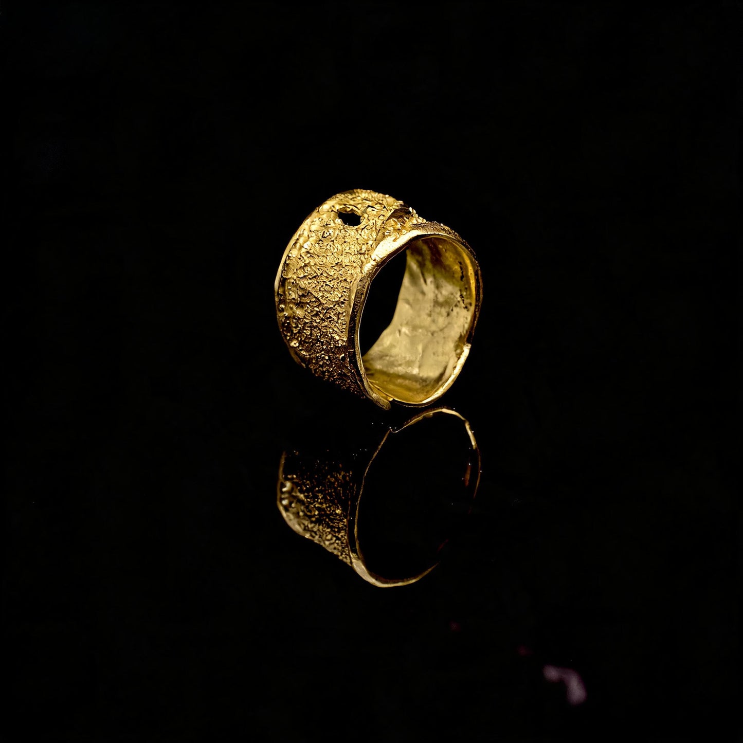 Gold textured open band ring with speckled hammered finish, angled view
