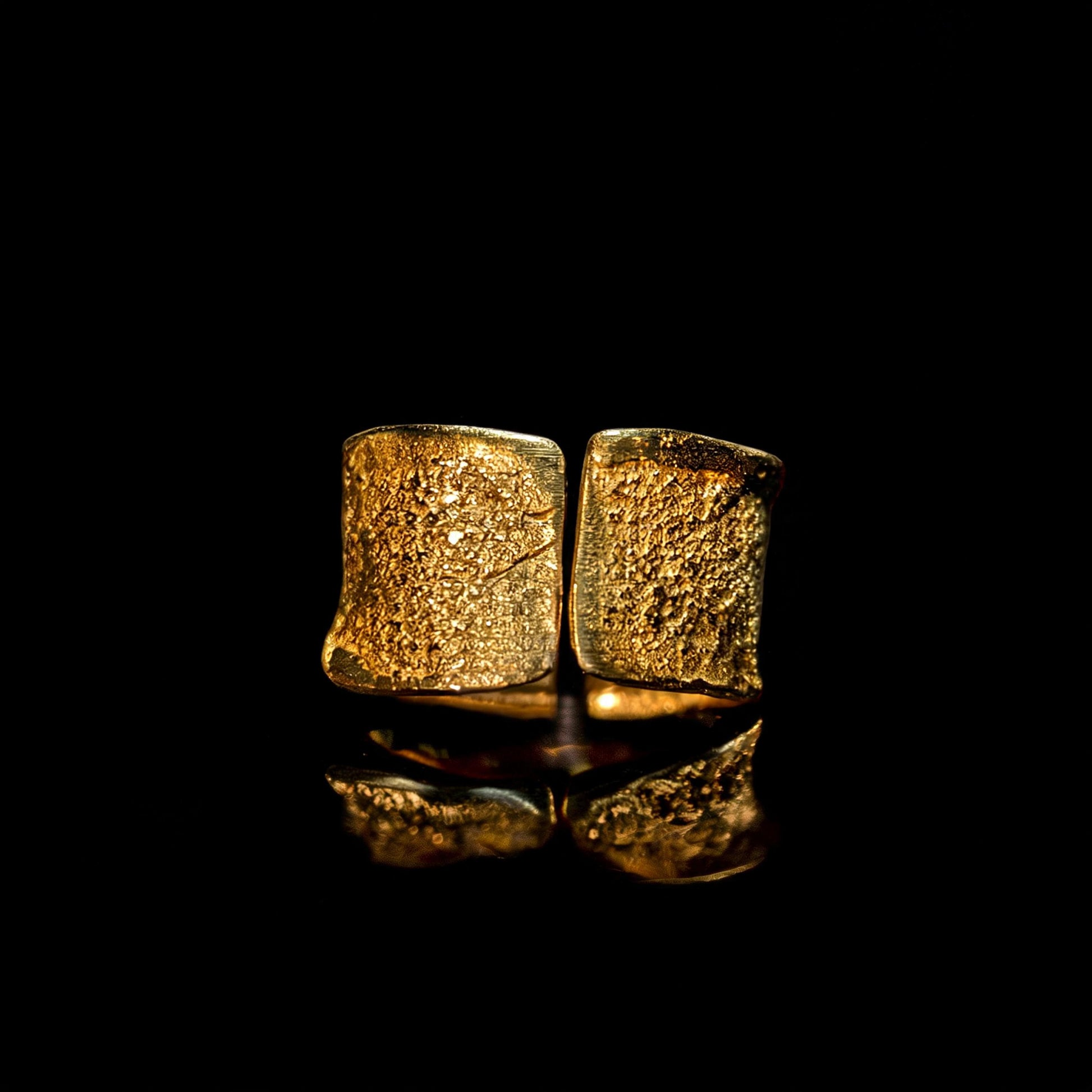 Gold hammered wide-band ring, front view with mirror-like reflection on surface