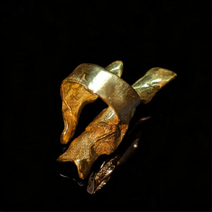 18K gold wave ring side view with glossy textured ridges