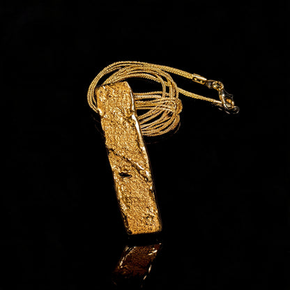 18K gold strata pendant necklace detail view of textured bar and braided chain
